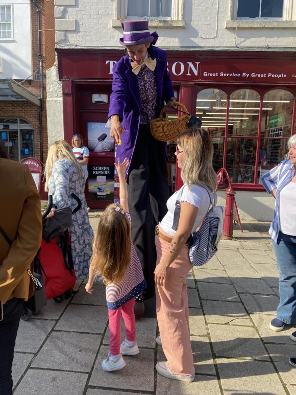 Willy Wonka Stilt Walker handing out chocolates